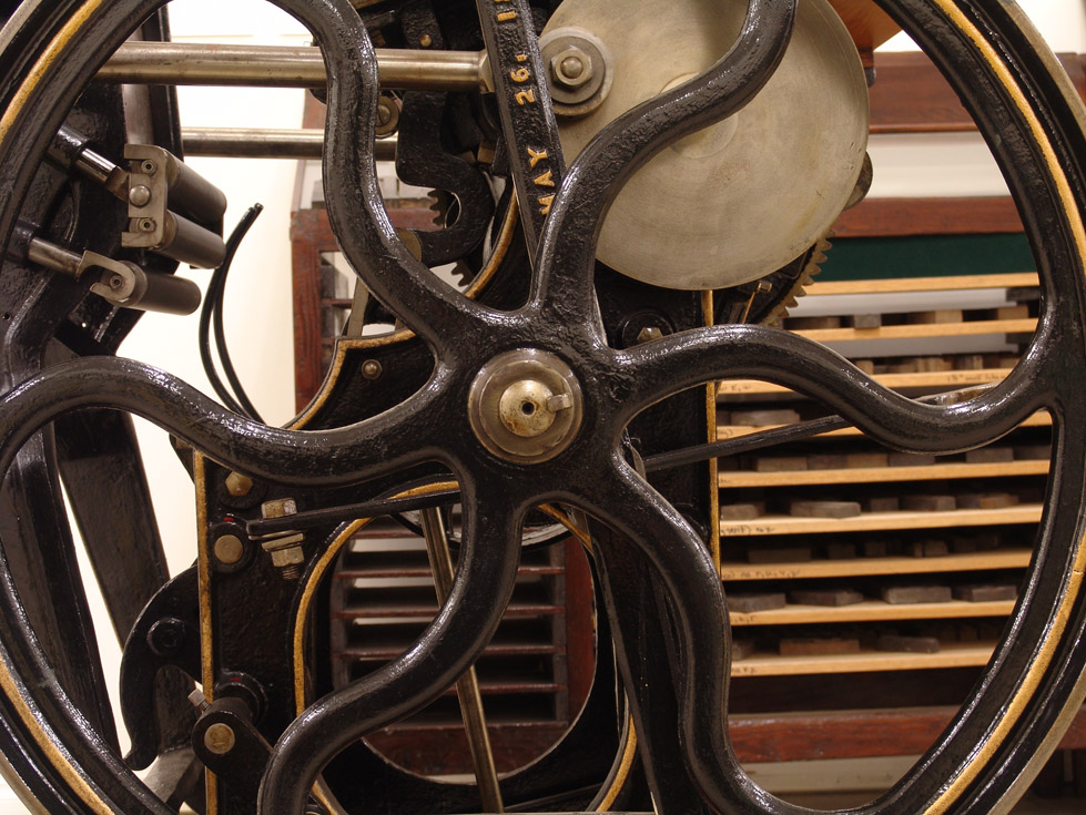 Close up of flywheel on an old printing press