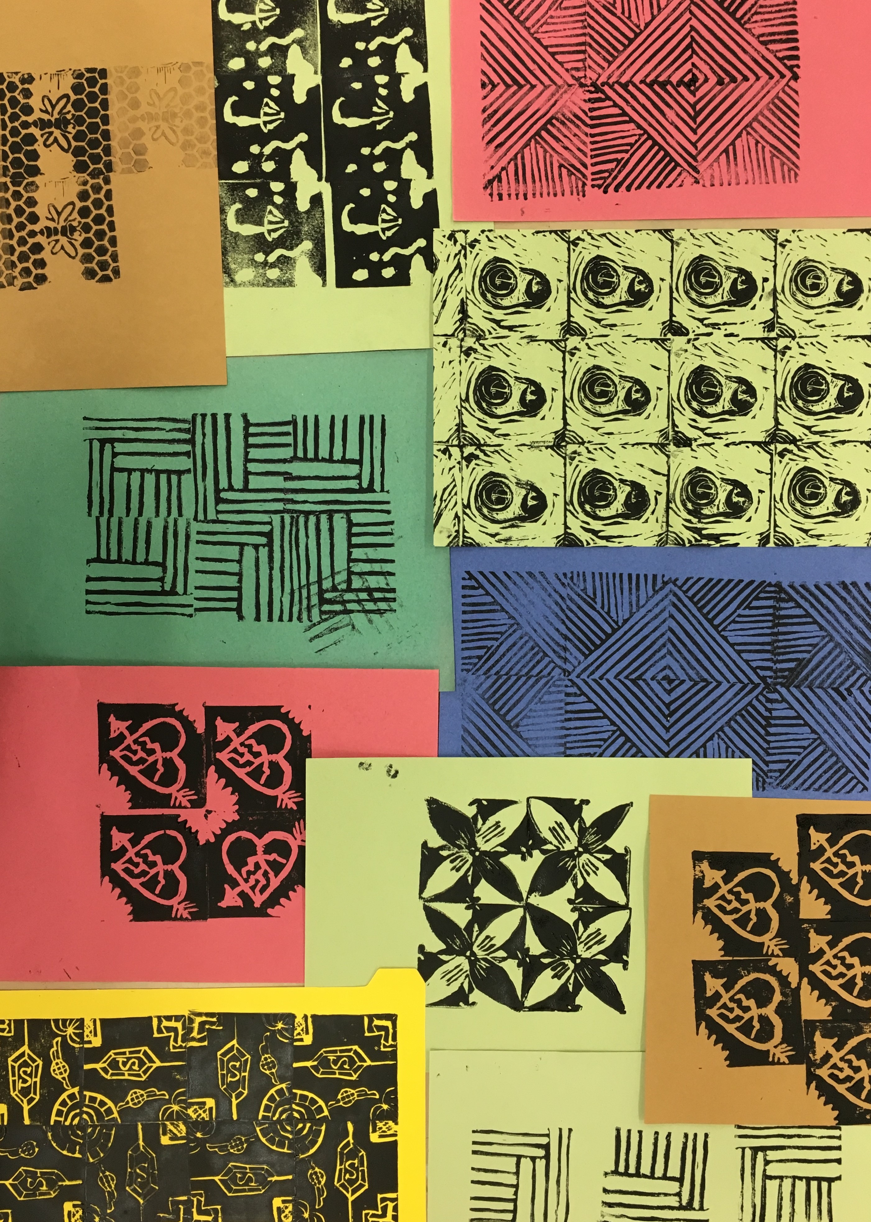 Pieces of coloured paper printed with graphic patterns in black